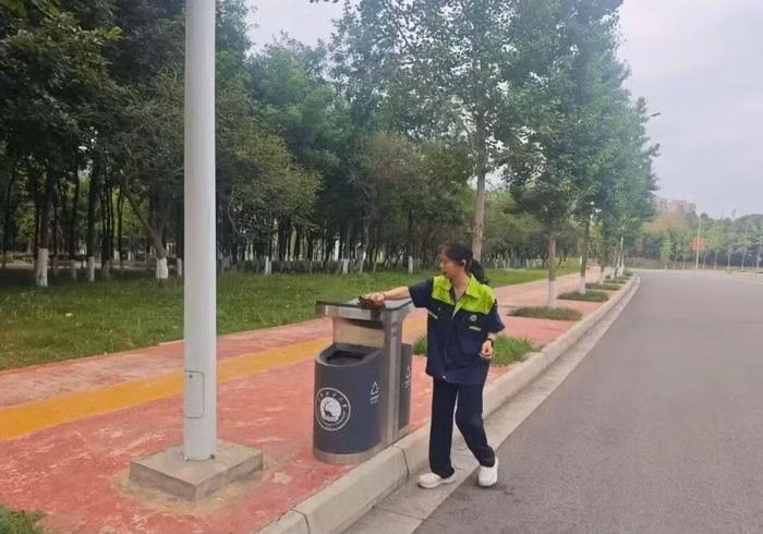 Cô Li dọn dẹp trong khuôn viên trường đại học. Ảnh: Baidu